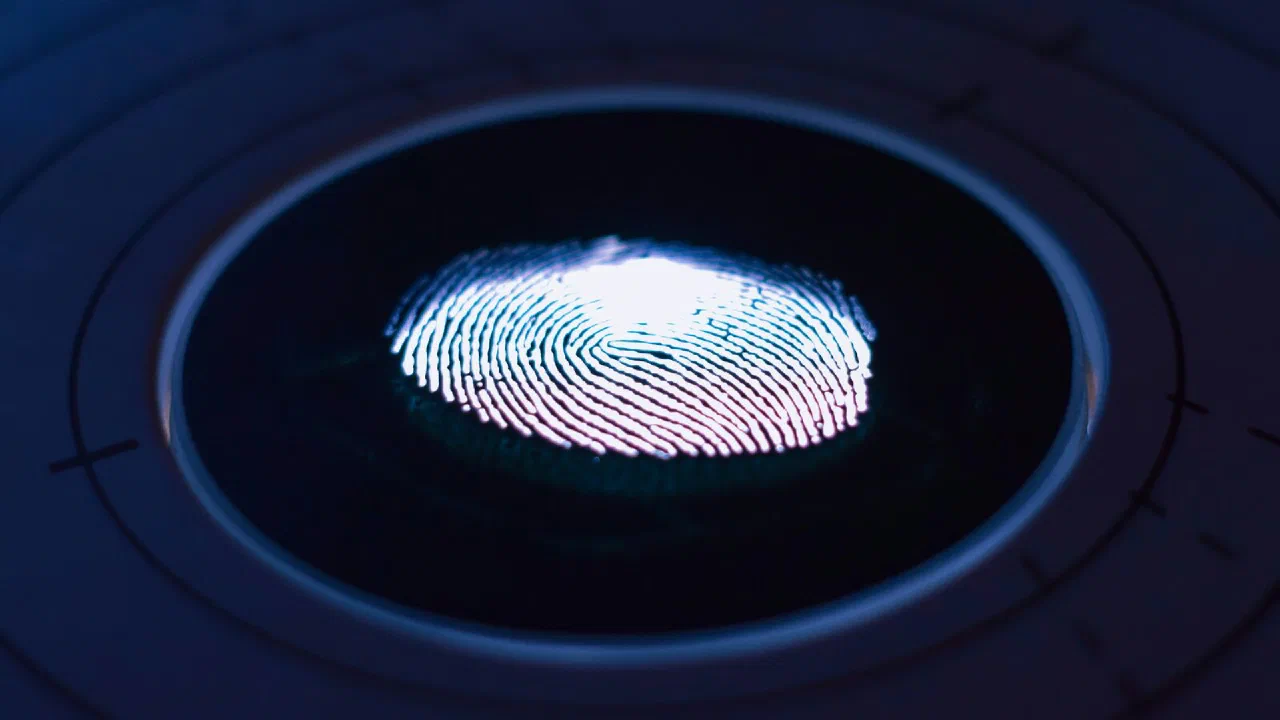 a glowing fingerprint on a dark circular scanner surface